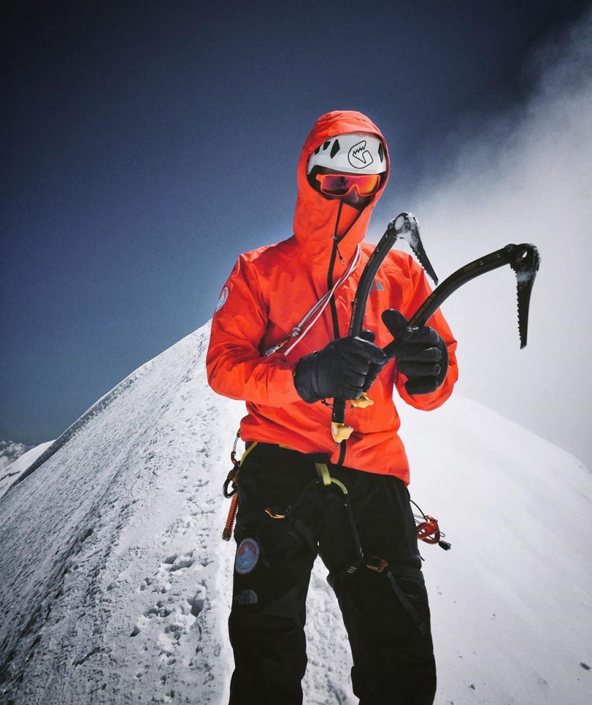 alpinist posing before the last climb with ice axe the dark machine from grivel