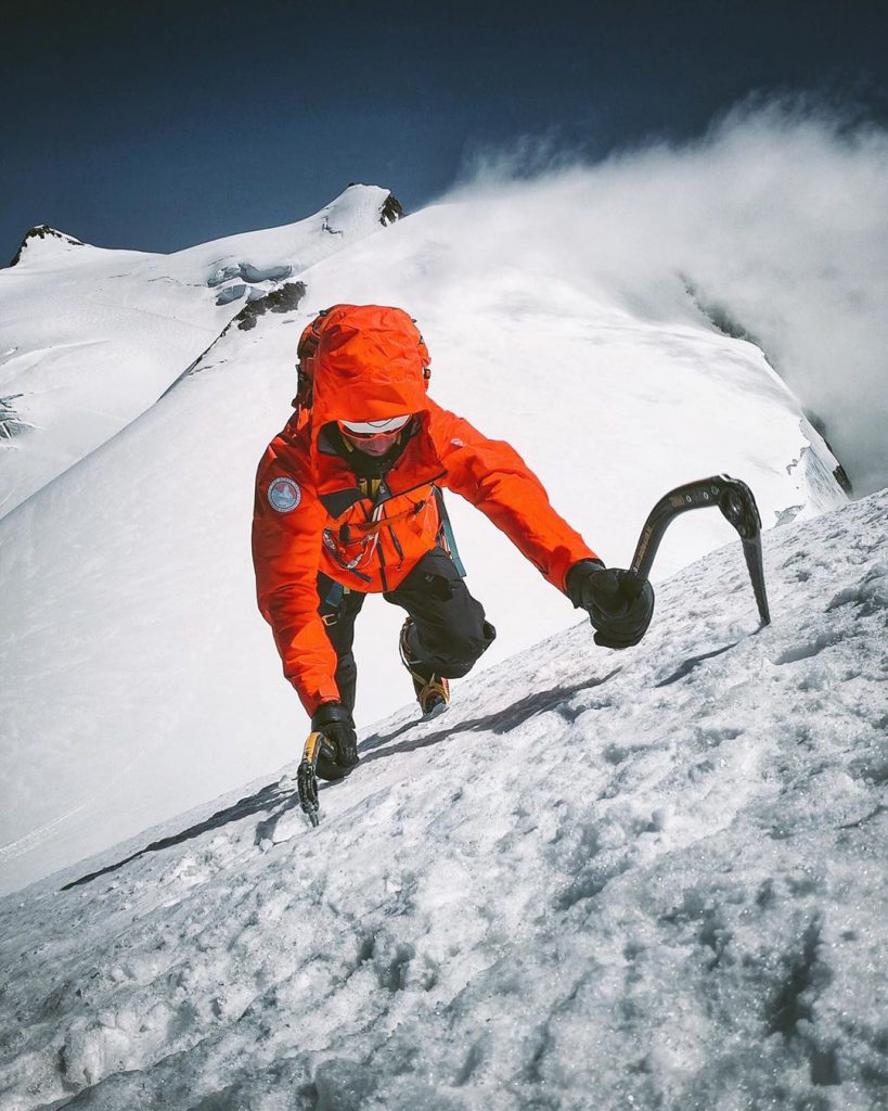 climbing a mountain with ice axe