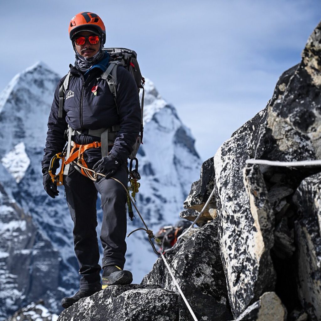 Black diamond helmet Vector used by Nirmal Purja while climbing the mountain with a snowy mountain in background