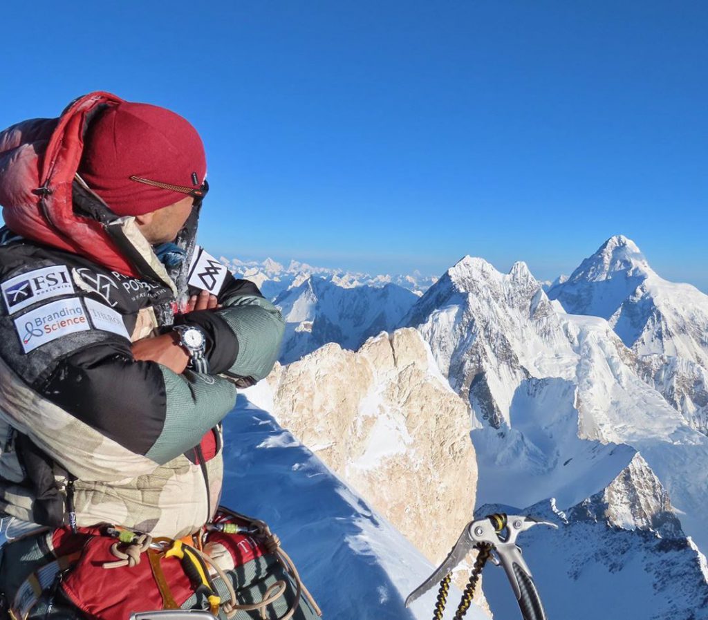 Nirmal Purja at the peak of the mountain with his cobra ice tool  black diamond