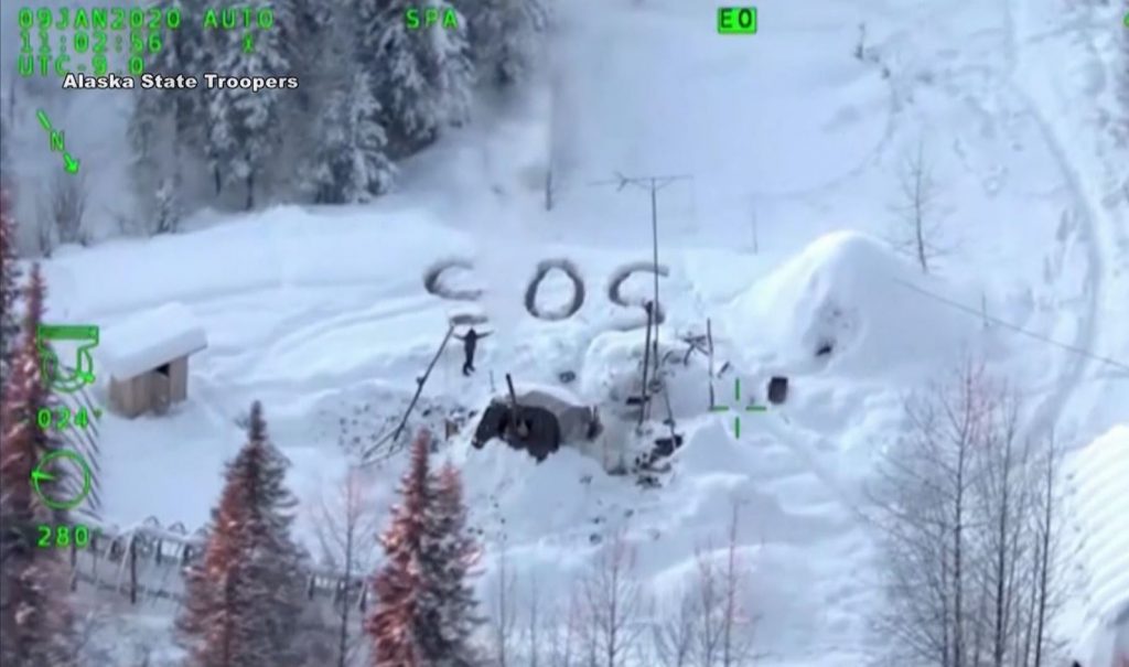 SOS signal on ground over with snow